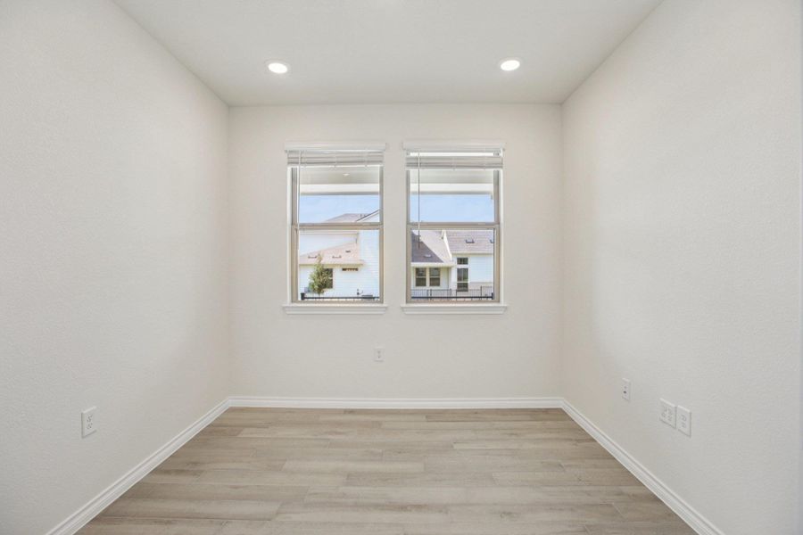 Spare room with light wood-style floors and recessed lighting