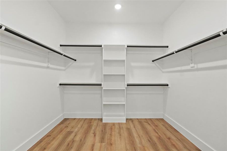 Walk in closet with light wood-type flooring