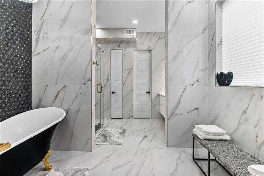 Bathroom with walk in shower, tile walls and separate free-standing  lack-gold tub