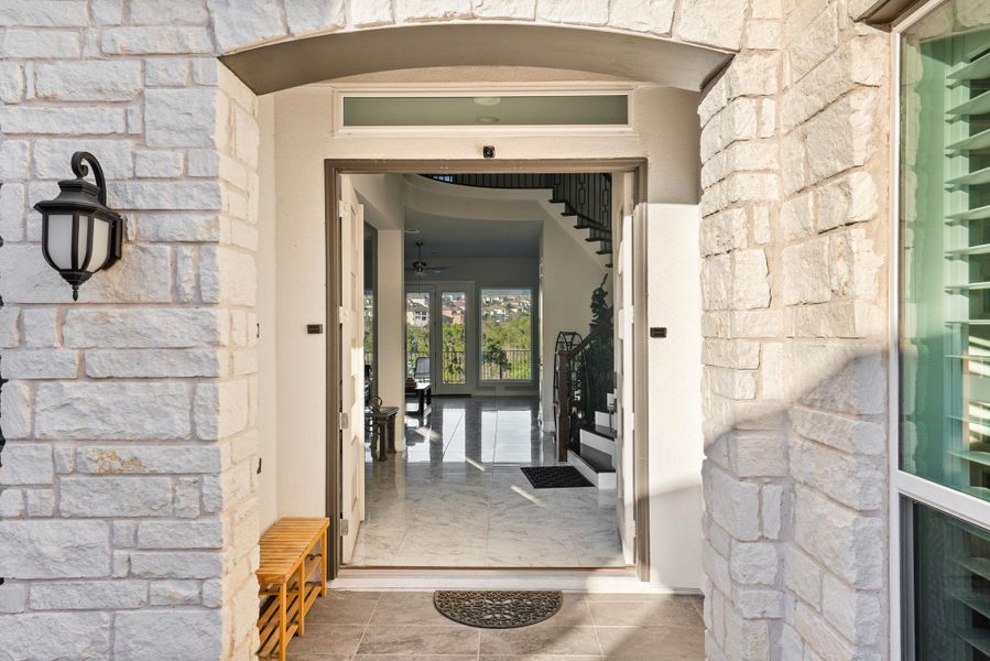 Entrance to property featuring french doors and stone siding