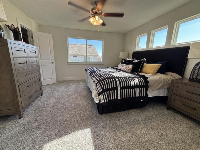 Bedroom with light carpet and ceiling fan