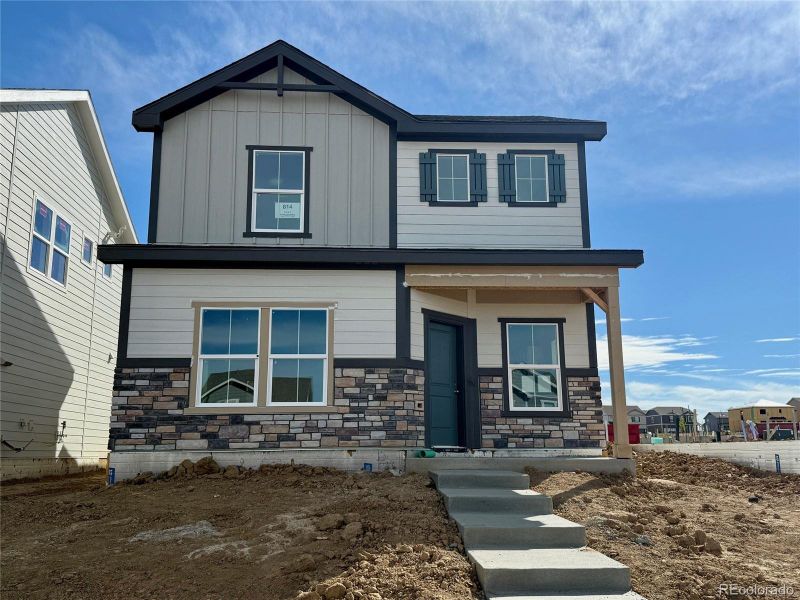 Front exterior of a new home in Sky Ranch – Uptown Collection, Watkins, CO, highlighting curb appeal (Image 1).