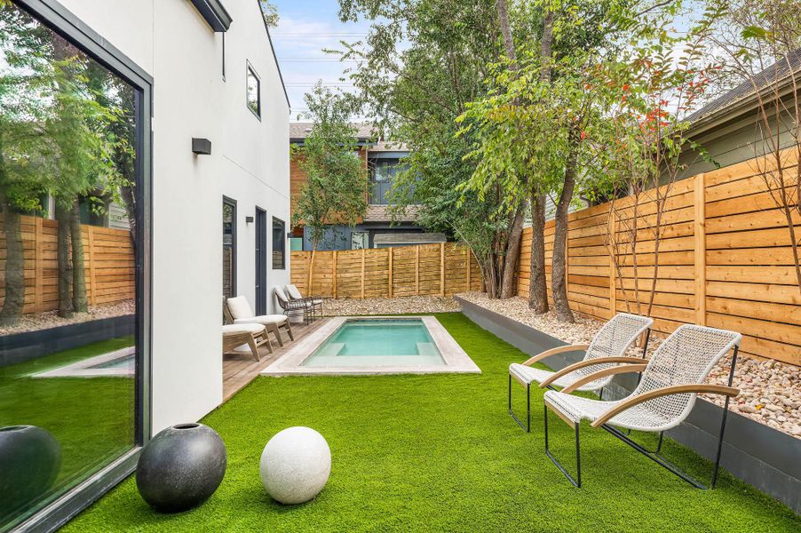 Backyard featuring zero-scaping, tress around providing privacy.