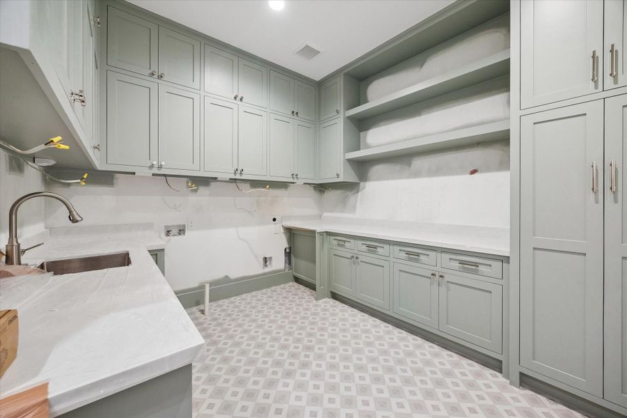 Large upstairs utility room with plenty of storage. Pictured April 2026.