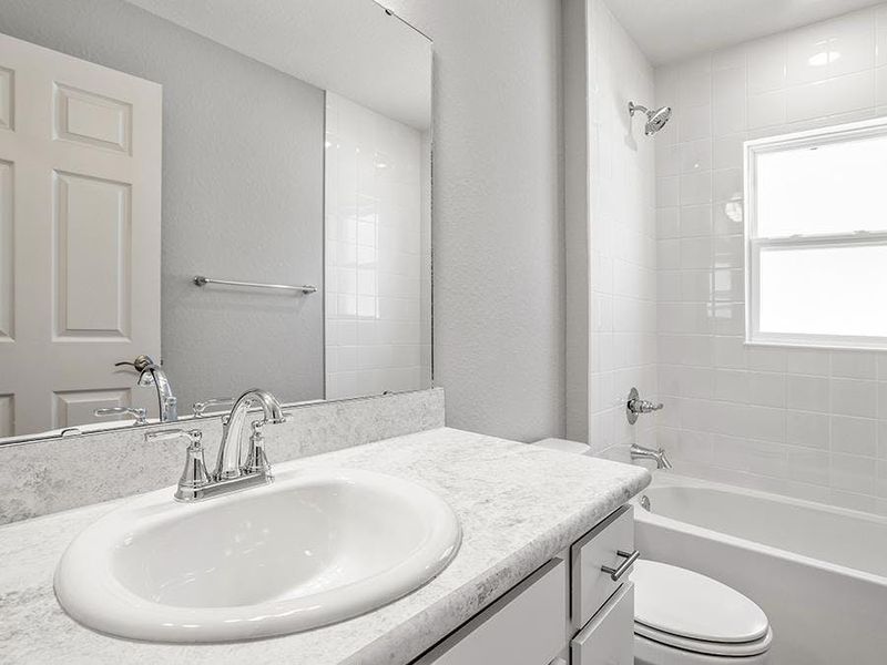 Secondary bedrooms share a convenient hall bath with extended counter space - Ashlyn by Highland Homes