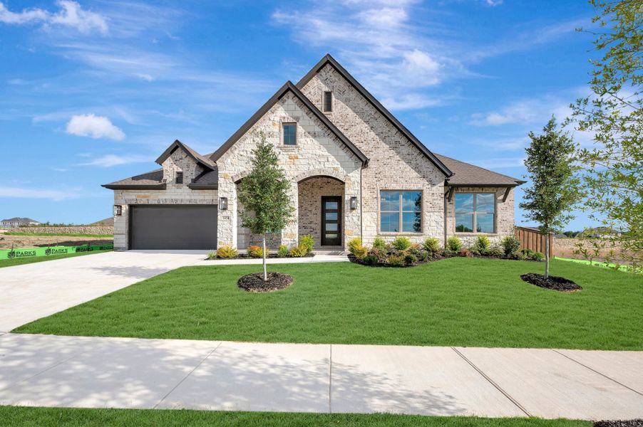 Front exterior of a new home in Monterra - Classics, Fate, TX, highlighting curb appeal (Image 1). Front exterior of a new home in Monterra - Classics, Fate, TX, highlighting curb appeal (Image 1).