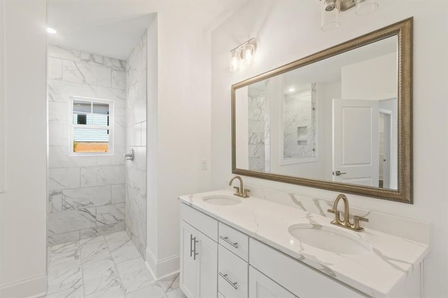 Gleaming stone counters and an elegant tile shower