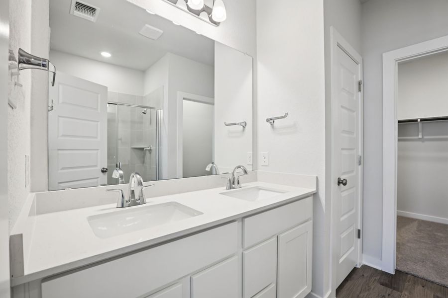 A bathroom with a large mirror.