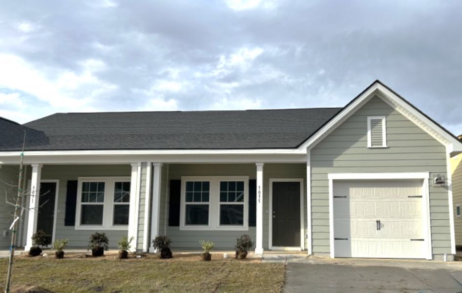 Front exterior of a new home in Tea Farm, Ravenel, SC, highlighting curb appeal (Image 2). Front exterior of a new home in Tea Farm, Ravenel, SC, highlighting curb appeal (Image 2).