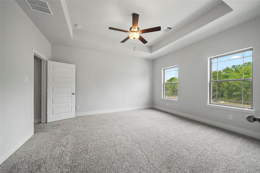 Primary bedroom with large windows