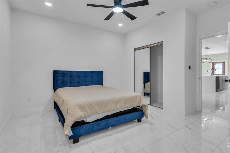 Bedroom featuring recessed lighting, a closet, marble finish flooring, and a ceiling fan Bedroom featuring recessed lighting, a closet, marble finish flooring, and a ceiling fan