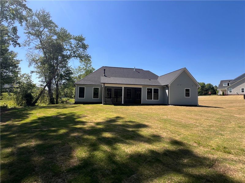 This home features a lush yard and a covered porch