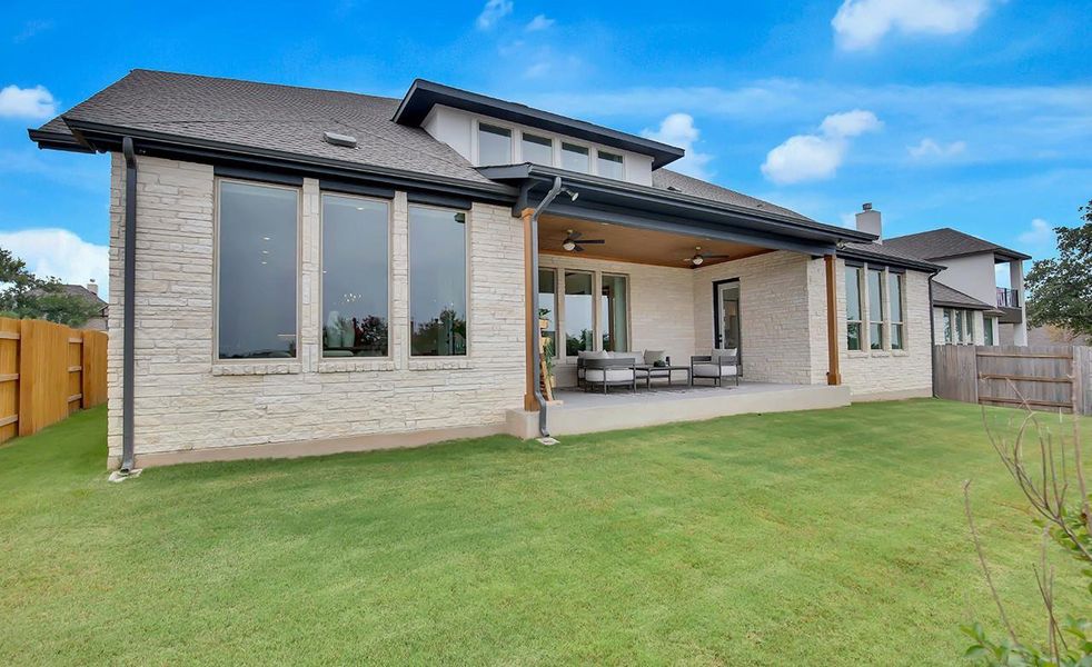 Rear view of house featuring a fenced backyard, a ceiling fan, an outdoor hangout area, and a patio