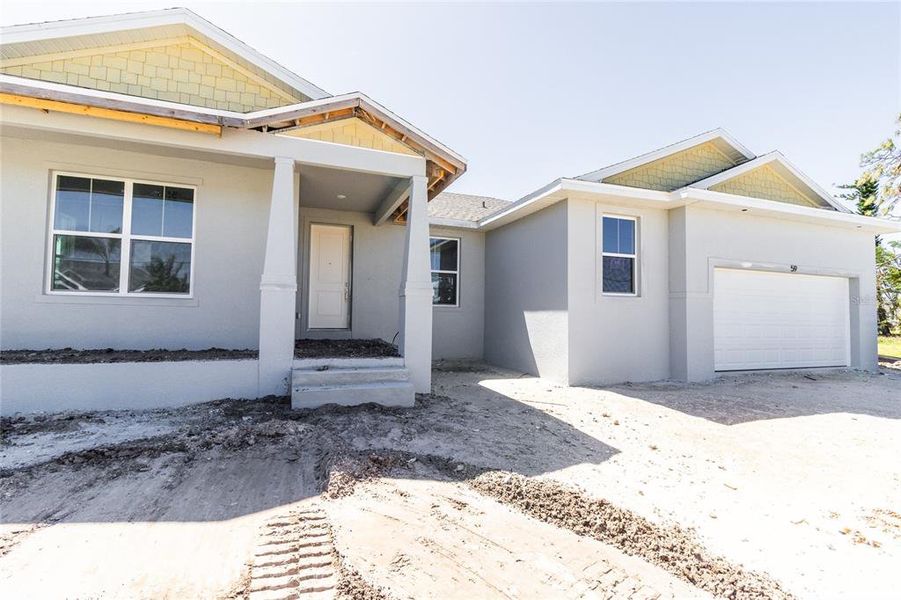Front exterior of a new home in , Rotonda West, FL, highlighting curb appeal (Image 23).