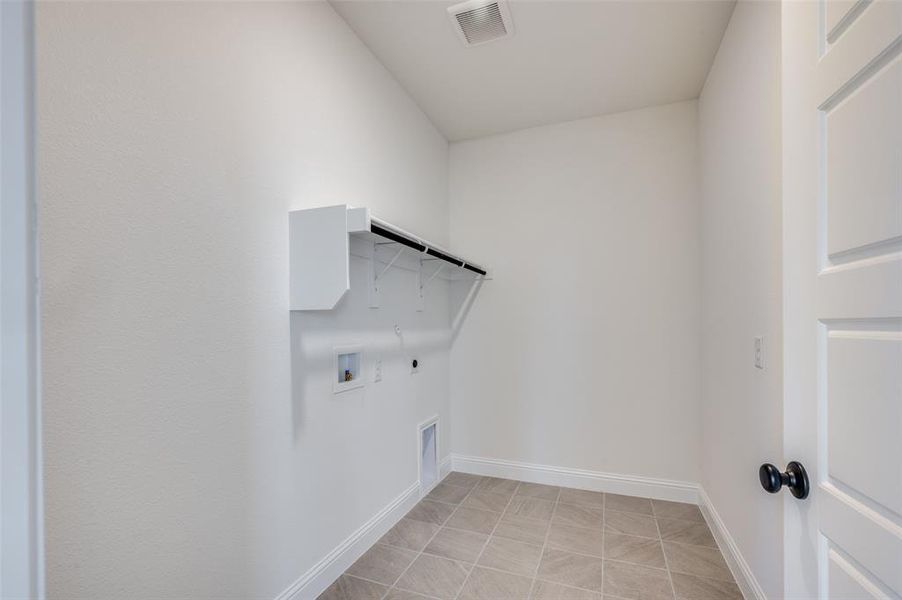 Laundry room with gas dryer hookup, electric dryer hookup, and washer hookup Laundry room with gas dryer hookup, electric dryer hookup, and washer hookup