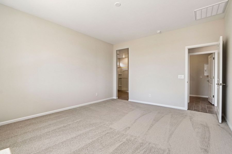 A room with a carpet and a door.