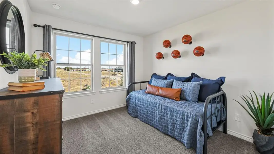 Room featuring two grid-pattern windows with dark curtain rods and drapes, a recessed ceiling light, and light gray carpet