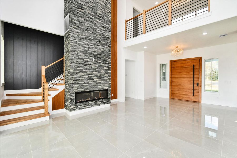 This soaring living space emphasizes the home's vertical scale and contemporary finishes. The seamless transition between levels is perfect for grand-scale entertaining.