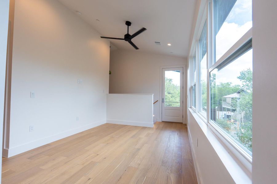 Bright hardwood flooring complements the naturally illuminated space with an overhead ceiling fan for optimal airflow. This is a multi-purpose room (den, office, playroom, library, or living). Bright hardwood flooring complements the naturally illuminated space with an overhead ceiling fan for optimal airflow. This is a multi-purpose room (den, office, playroom, library, or living).