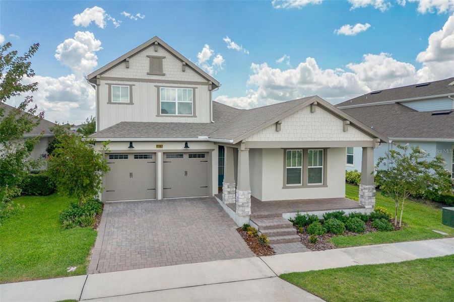 Front exterior of a new home in Laureate Park, Orlando, FL, highlighting curb appeal (Image 22). Front exterior of a new home in Laureate Park, Orlando, FL, highlighting curb appeal (Image 22).