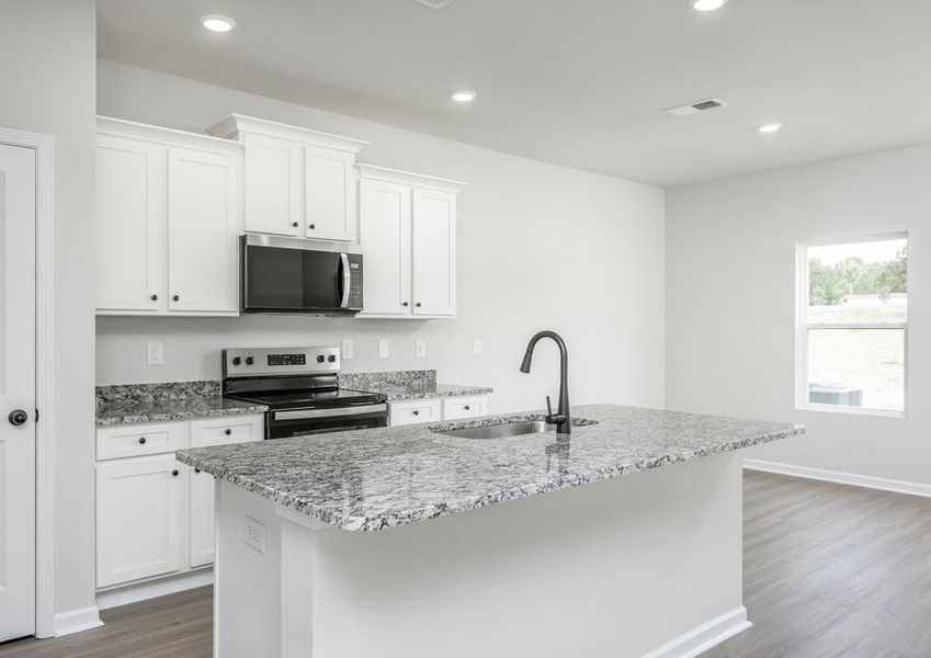 The kitchen opens to the dining area