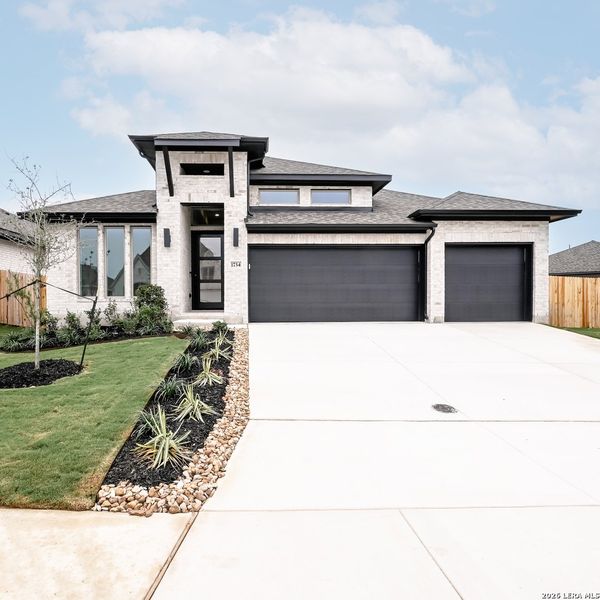 Front exterior of a new home in Meadows of Mill Creek, Seguin, TX, highlighting curb appeal (Image 1). Front exterior of a new home in Meadows of Mill Creek, Seguin, TX, highlighting curb appeal (Image 1).