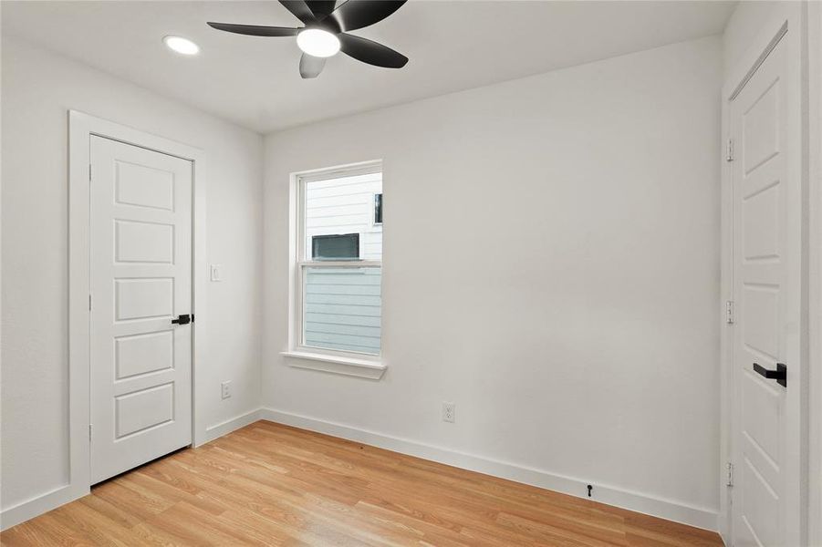 Unfurnished bedroom featuring ceiling fan and light wood-type flooring