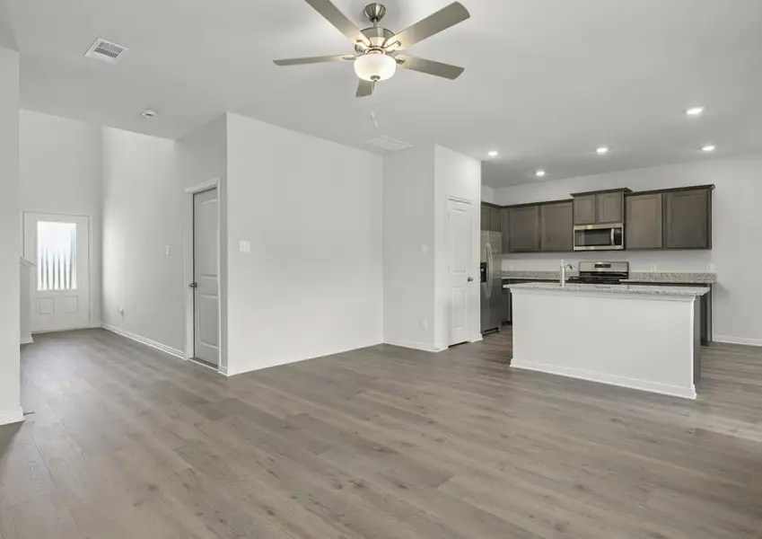 The kitchen and living room sit adjacent to one another. The kitchen and living room sit adjacent to one another.