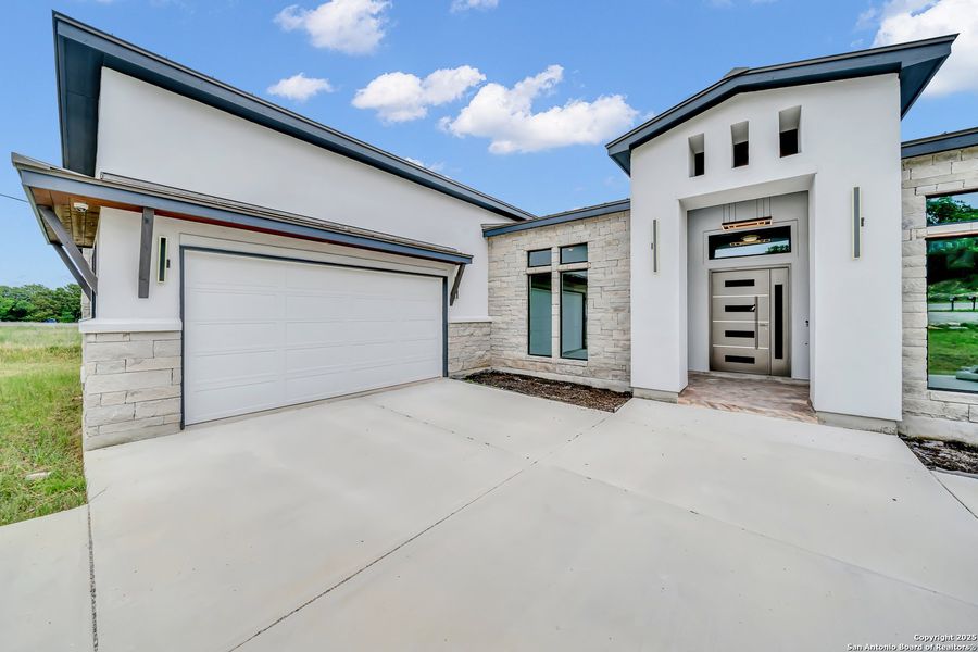 Front exterior of a new home in , Spring Branch, TX, highlighting curb appeal (Image 19). Front exterior of a new home in , Spring Branch, TX, highlighting curb appeal (Image 19).