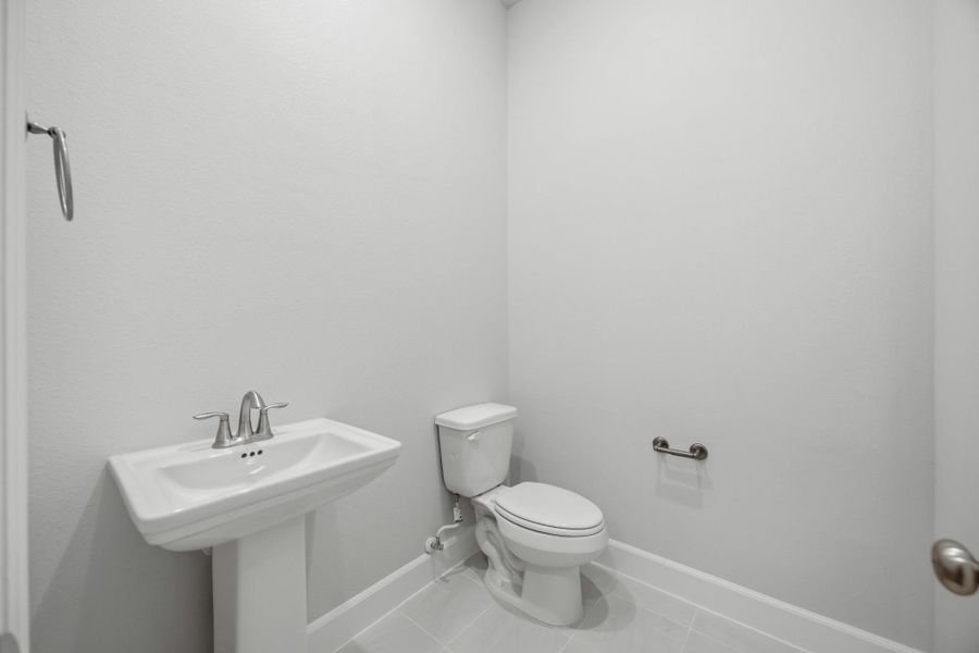 This powder bath may be petite, but it’s polished to perfection. With sleek fixtures and a splash of charm, it’s the kind of space guests will remember.