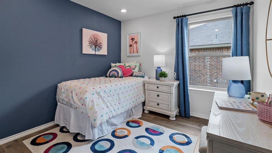 Bedroom with wood finished floors and recessed lighting Bedroom with wood finished floors and recessed lighting