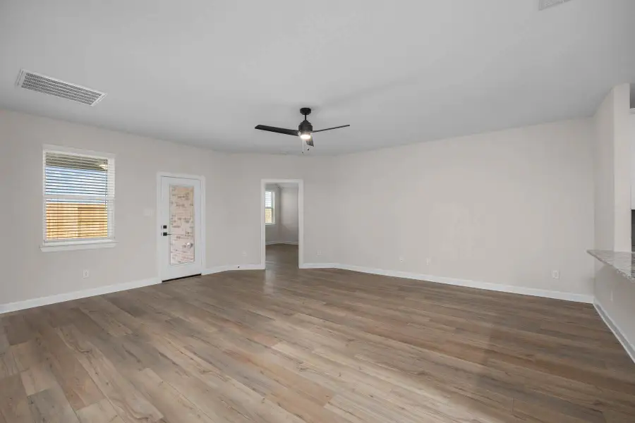 This large family room has a perfect view of the backyard, which is great for entertaining guests or just relaxing with family. The close proximity to the kitchen makes entertaining a breeze.