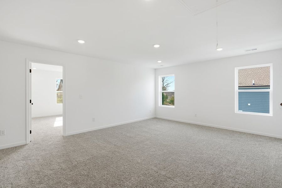 A room with white walls and windows.