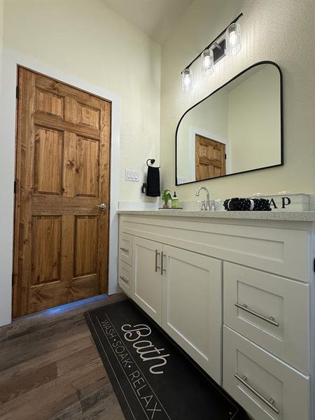 Stained wood door, white shaker cabinets self closing with hardware.