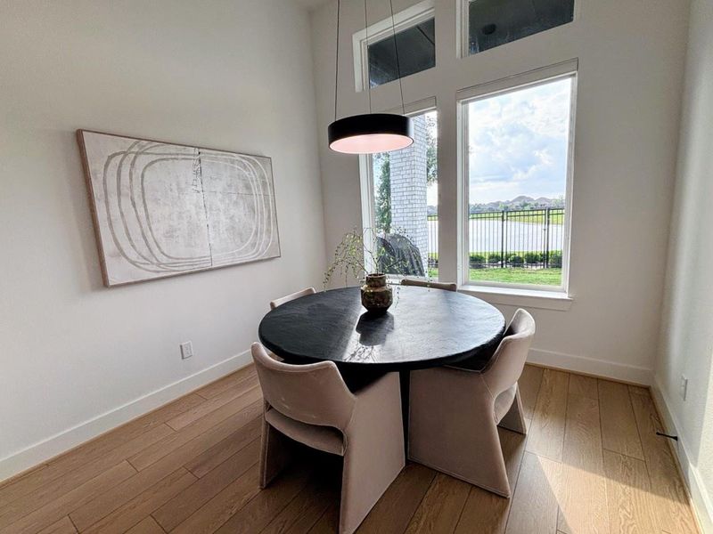 The dining area features a large windows offering a scenic outdoor view.