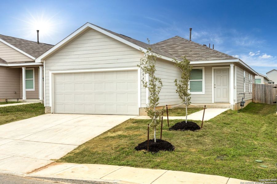 Front exterior of a new home in Ruby Crossing: Cottage Collection, San Antonio, TX, highlighting curb appeal (Image 1).