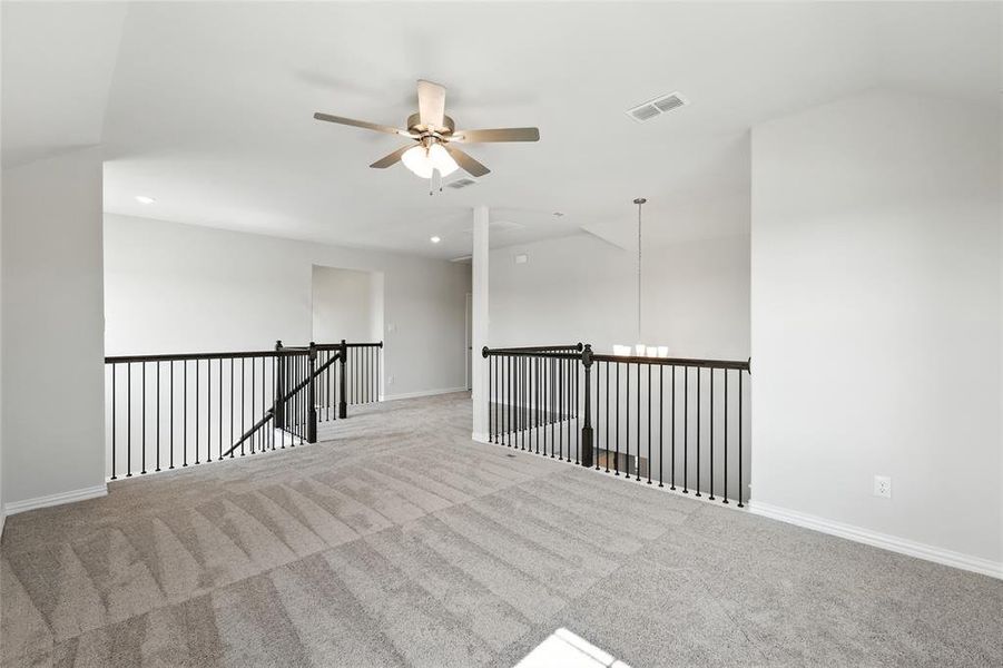 Spare room featuring carpet and a ceiling fan Spare room featuring carpet and a ceiling fan