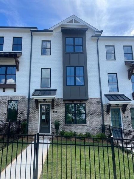 Front exterior of a new home in Palisades Townhomes, Cumming, GA, highlighting curb appeal (Image 28).