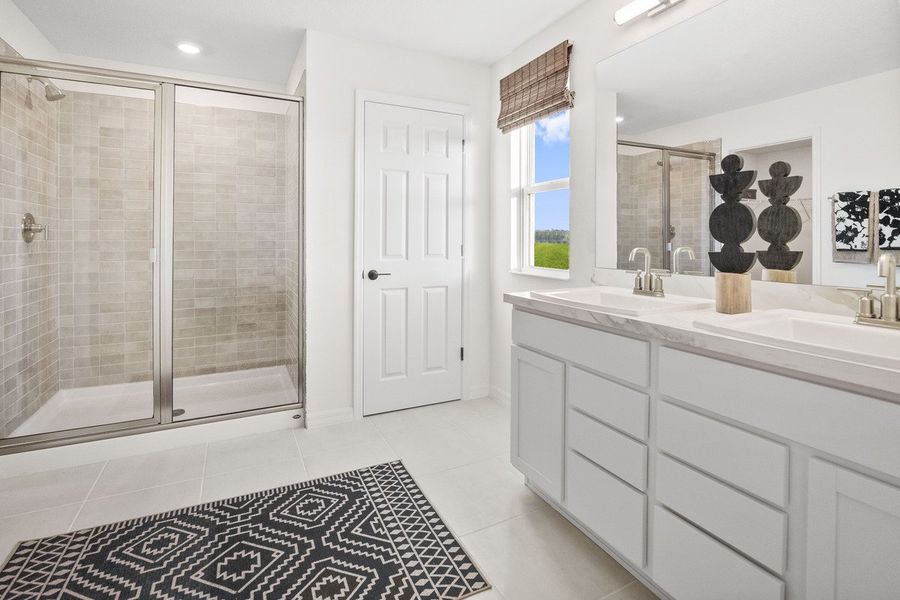 Walk-in shower with tile surround at primary bath Walk-in shower with tile surround at primary bath