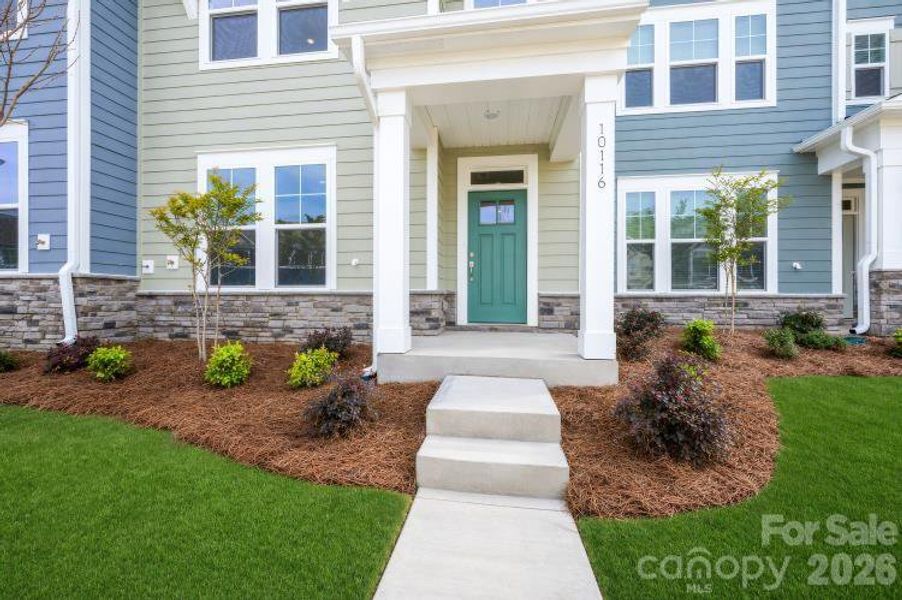 Exterior details and patio area of a home in North Creek Village - Townhomes, Huntersville (Image 3).