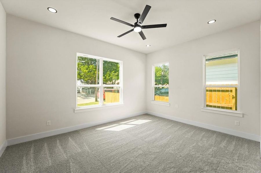 Unfurnished room featuring light carpet, plenty of natural light, recessed lighting, and ceiling fan Unfurnished room featuring light carpet, plenty of natural light, recessed lighting, and ceiling fan