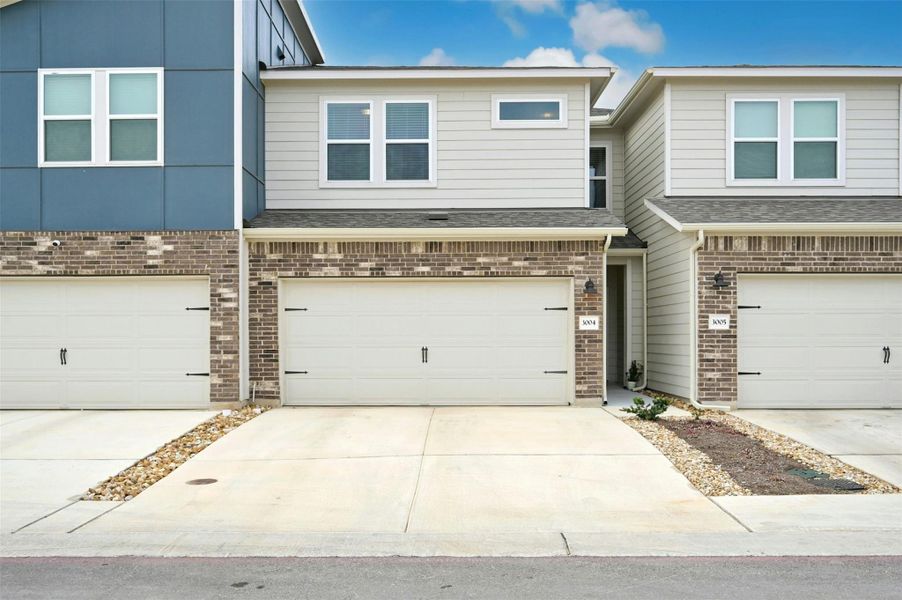 View of property featuring a garage