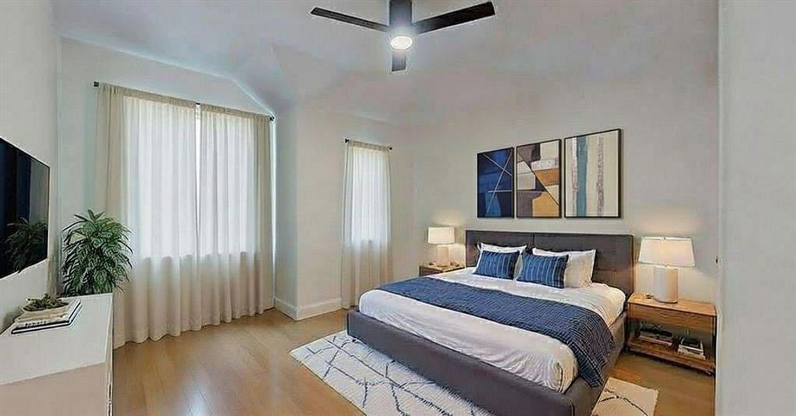 Bedroom featuring wood finished floors and ceiling fan