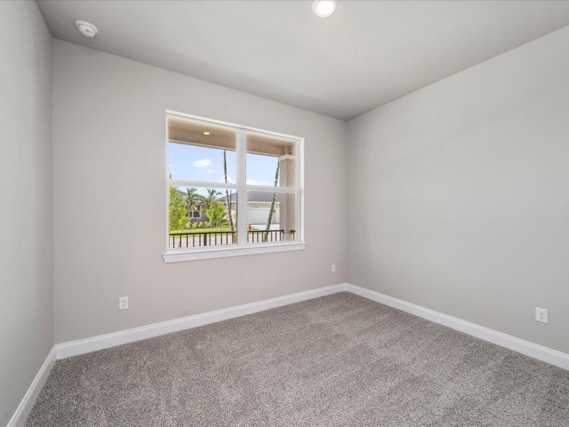 Bedroom in the Coral floorplan at 6326 NW Sweetwood Drive in Brystol at Wylder