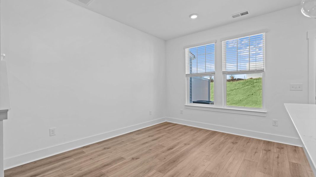 Tasteful breakfast area with current design in this vibrant two-story townhome in Anderson, SC