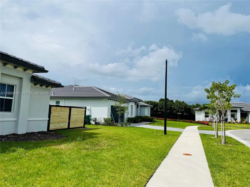 Front exterior of a new home in , Homestead, FL, highlighting curb appeal (Image 14).