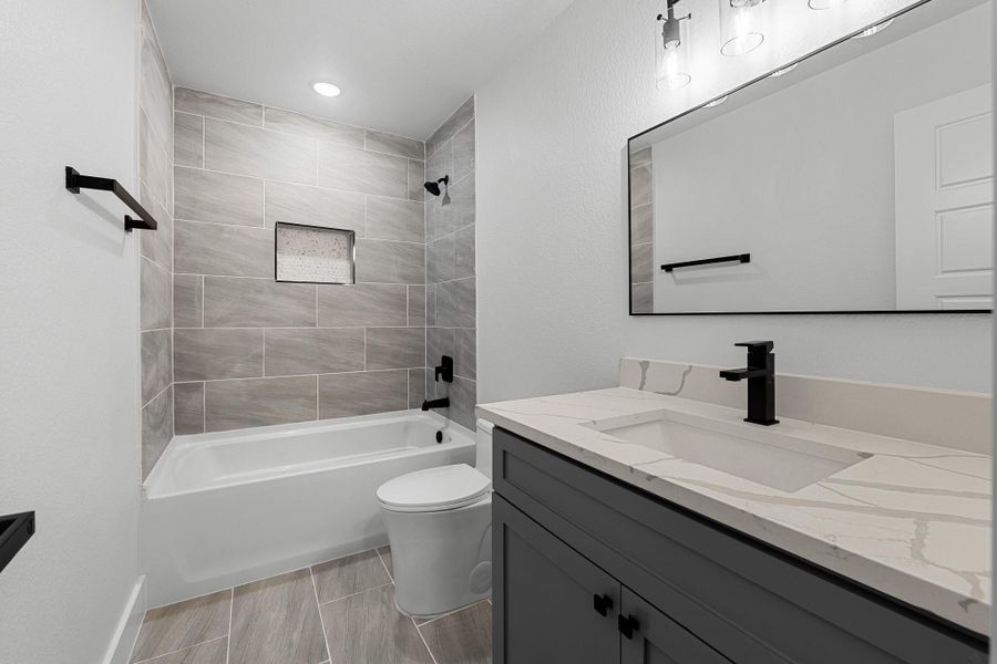 Stylish upstairs guest bathroom with modern fixtures and elegant tilework. Stylish upstairs guest bathroom with modern fixtures and elegant tilework.