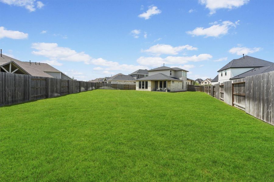 The expansive backyard is one of the largest lots in the neighborhood, offering immense potential for outdoor living. This huge space can easily accommodate a future pool, outdoor kitchen, or playscape, allowing you to create your perfect oasis.