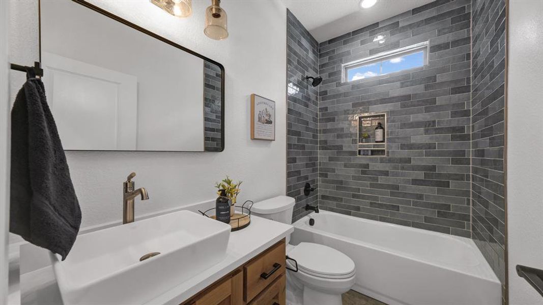 Tiled tub/shower combo in the 2nd hall bath.