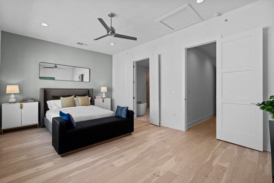 Smooth wood floors and recessed lighting enhance this airy bedroom suite. Smooth wood floors and recessed lighting enhance this airy bedroom suite.